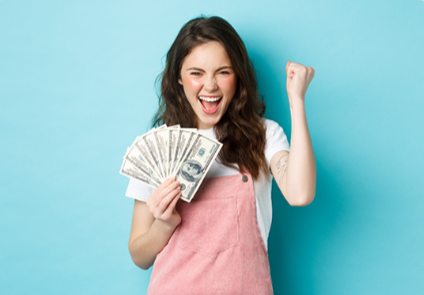 A woman holding up currency on a blue background.